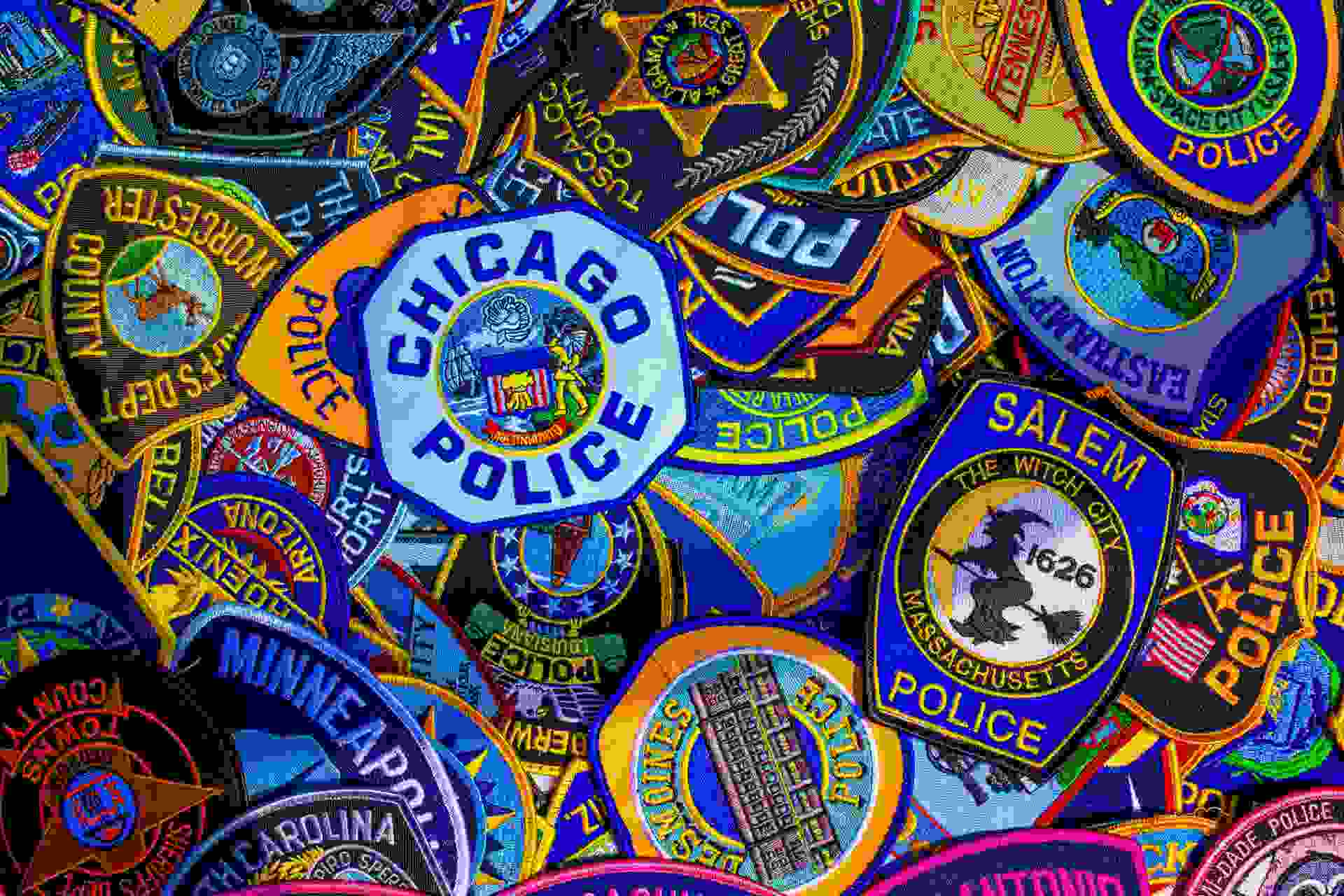 a variety of police badges from different US states