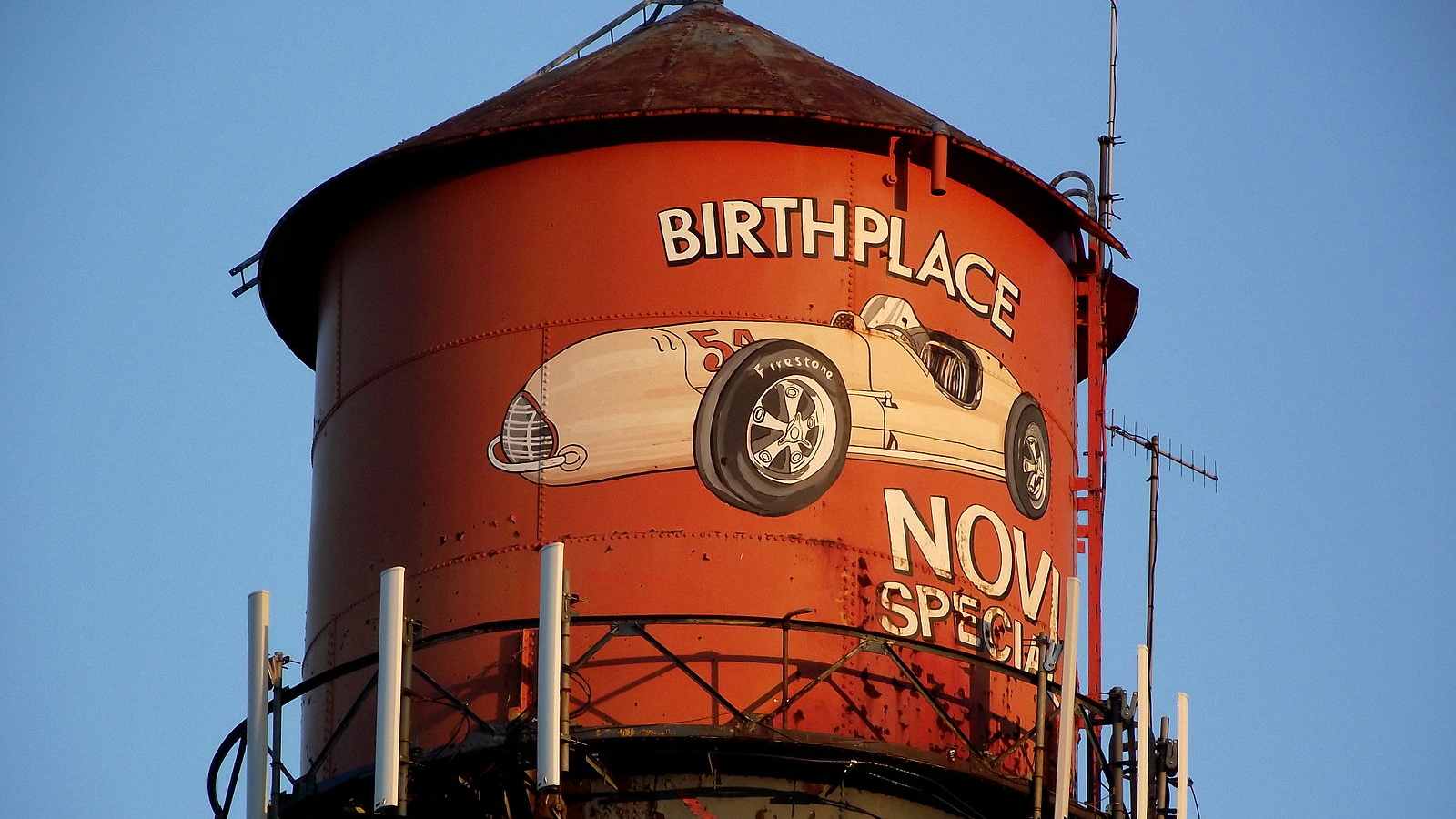 A close up of Novi, Michigan's famous water tower featuring a derby car