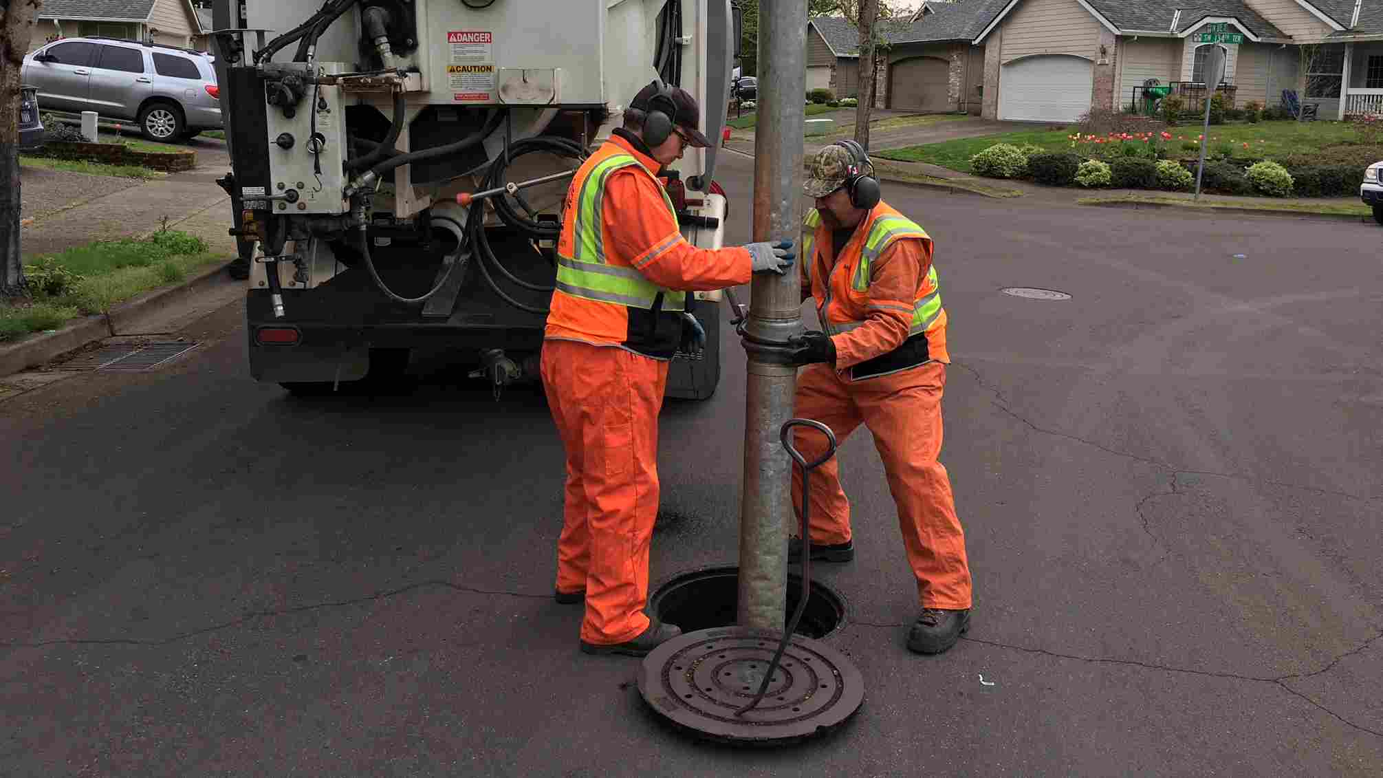 two tualatin public works employees maintaining the stormwater system